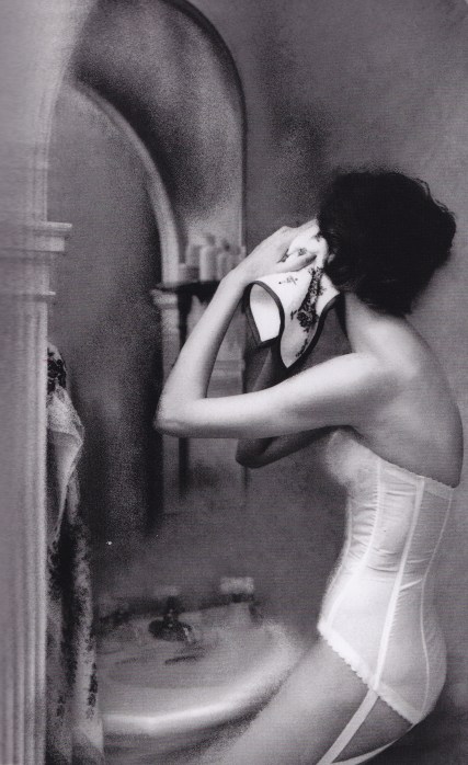 Lillian Bassman, woman looking in the mirror, white basque
